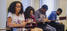 Malia, a student at SJI writing an article