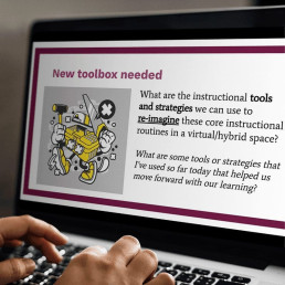 Hands typing on a laptop, with presentation slide open that reads 