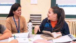 student and teacher working together at table